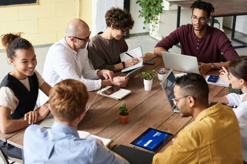 Photo by fauxels: https://www.pexels.com/photo/photo-of-people-sitting-near-wooden-table-3182796/